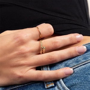 Elegant gold snake wrap ring set with minimalist thin band shown on person