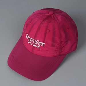 Magenta quick-dry baseball cap with white Dreams Come True embroidery and stitched brim
