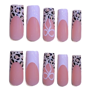 Pink leopard print press-on nails with 3D white bow lines and long trapezoid shape