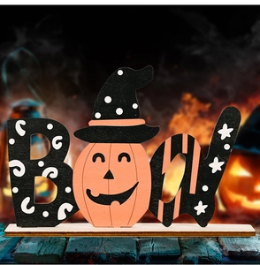 Macro shot of Halloween BOO wood sign with orange pumpkin and witch hat tabletop decor