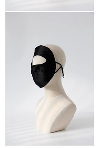 Detail of premium black silk sleep mask showing material texture on a mannequin head