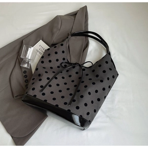 Polka dot bucket bag detail with grey wool fabric and black patent leather strap