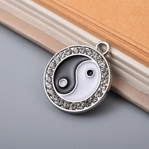 Macro detail of Yin Yang pendant with silver finish and white crystal accents