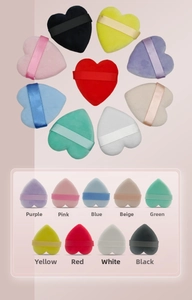 Detail shot of heart-shaped makeup puffs in nine colors with matching ribbon handles