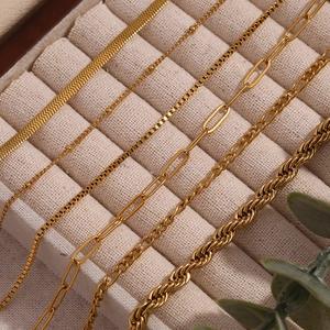 Macro detail of various 18K gold plated stainless steel chains in different textures