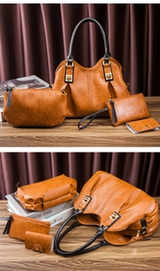 Detail view of brown PU leather bag set including tote and pouches with gold hardware