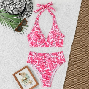 Tropical floral high-waist bikini set with halter top on vacation accessories background