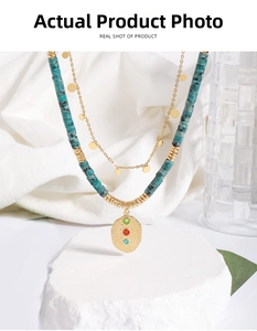 Detail of bohemian double-layered turquoise bead necklace with a gold coin pendant