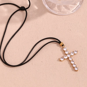 Minimalist gold-plated stainless steel cross necklace with cubic zirconia on black cord