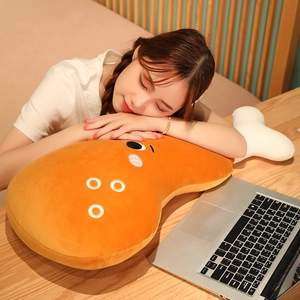 Close-up of soft plush chicken leg pillow with cute cartoon eyes and white bone detail