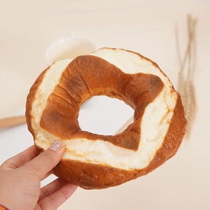 Realistic German pretzel bread model for home decor and fridge magnets displayed on a table