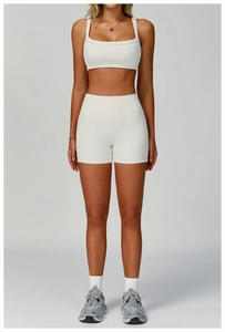 Detail of white ribbed high-waist fitness shorts and square-neck sports top set