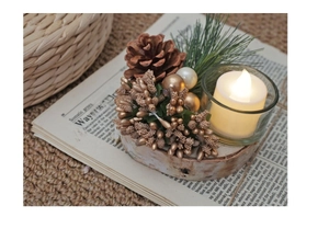Close-up of wooden base Christmas candle holder with golden berries and pine cones