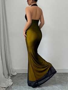 Detail of olive green backless halter dress with sheer black mesh hem and satin finish