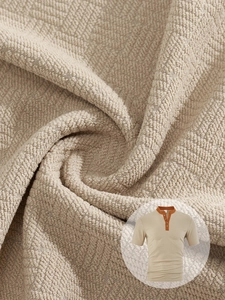 Macro texture of jacquard fabric on a men's polo shirt with an orange collar detail