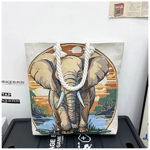 Detail of artistic canvas tote bag with elephant print and thick white rope handles