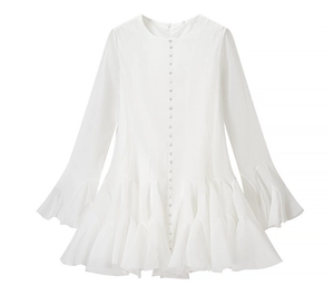 Detail of white mini dress featuring tiered ruffle hem and trumpet sleeves with buttons