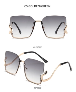Detail view of square gradient lenses and wavy gold metal temples on fashion sunglasses