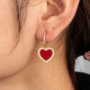 French vintage gold hoop earrings with red micro-pave heart charm on female model
