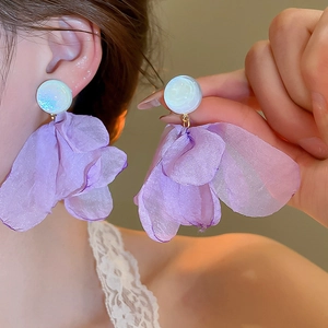 Close-up of lightweight purple organza petal earrings with white pearl studs
