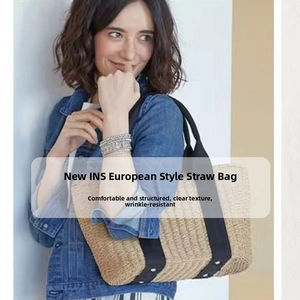 Close-up of woven straw handbag texture with black canvas handle and silver metal rivets