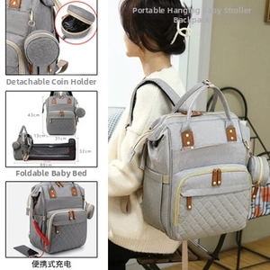 Detail of grey quilted diaper backpack with USB port and foldable travel crib function