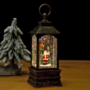 Antique bronze Christmas lantern featuring Santa and swirling glitter snow effect