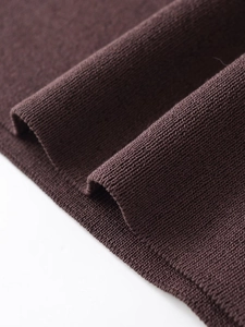 Close-up of premium dark brown knitted fabric texture and fine hemline detail