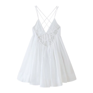 White backless mini dress featuring delicate criss-cross straps and lace-up details