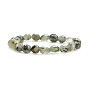 Macro detail of natural green prehnite bracelet with black needle-like inclusions and stones