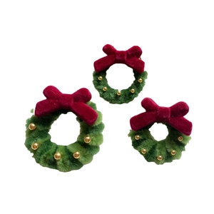 Three handmade green chenille Christmas wreaths with red velvet bows and gold bead accents