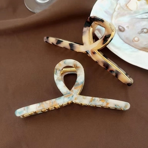 Elegant large acetate claw clips in tortoiseshell and marble patterns with metal teeth