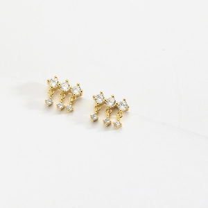 Macro shot of S925 sterling silver gold earrings with sparkling triple rows of cubic zirconia