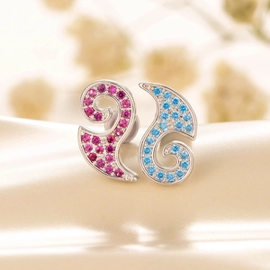 Elegant silver screw stud earrings with pink and blue zircons on silk background