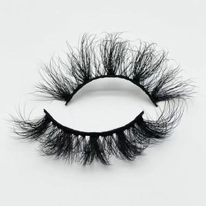 Macro shot of 20mm thick curly faux mink eyelashes with fluffy layered texture on white