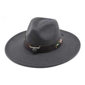 Detail of grey wool fedora hat featuring floral embroidered band and metal bull head
