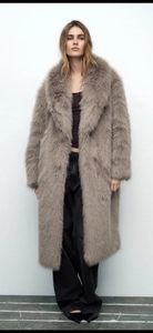 Detail of taupe faux fox fur coat with plush texture and wide shawl collar design