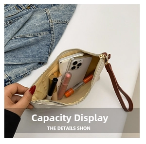 Interior view of straw envelope bag showing capacity for phone and cosmetics