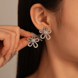 Elegant silver-plated hollow flower earrings with sparkling cubic zirconia crystals