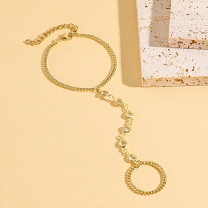 Macro detail of gold finger bracelet chain with inlaid zircons and adjustable lobster clasp