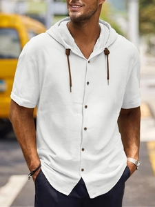 Detail of white cotton linen shirt showing hood texture, brown drawstrings and buttons