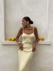 Elegant yellow knitted halter maxi dress for women styled with golden jewelry in summer