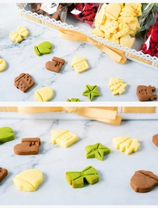 Close-up of Christmas cookies in gingerbread and snowflake shapes on marble background
