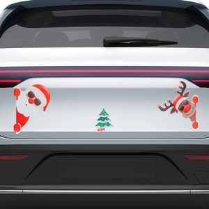 Close-up of festive Santa, reindeer and tree magnetic car stickers on a white vehicle