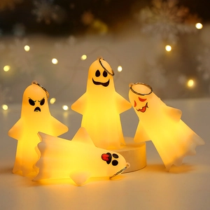 Macro shot of four cute LED ghost figurines with glowing expressions for Halloween decor