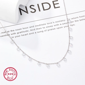 Macro detail of S925 sterling silver necklace with faceted water-drop zircon beads