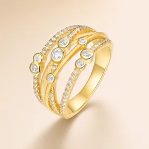 Detailed view of multilayer gold-plated silver ring with circular moissanite settings
