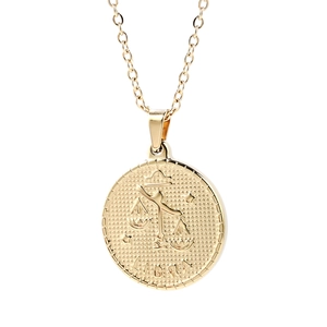 Golden Libra zodiac coin pendant necklace with embossed scales on minimalist link chain