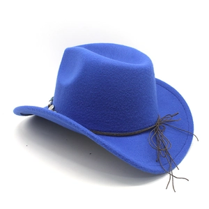 Detail of royal blue wool felt cowboy hat featuring ethnic braided strap and metal bead