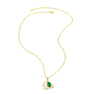 Detail of golden elephant pendant with white pearls and a green gemstone on a fine chain